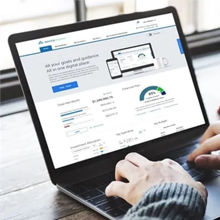 Laptop showing a financial planning dashboard with a goal confidence gauge